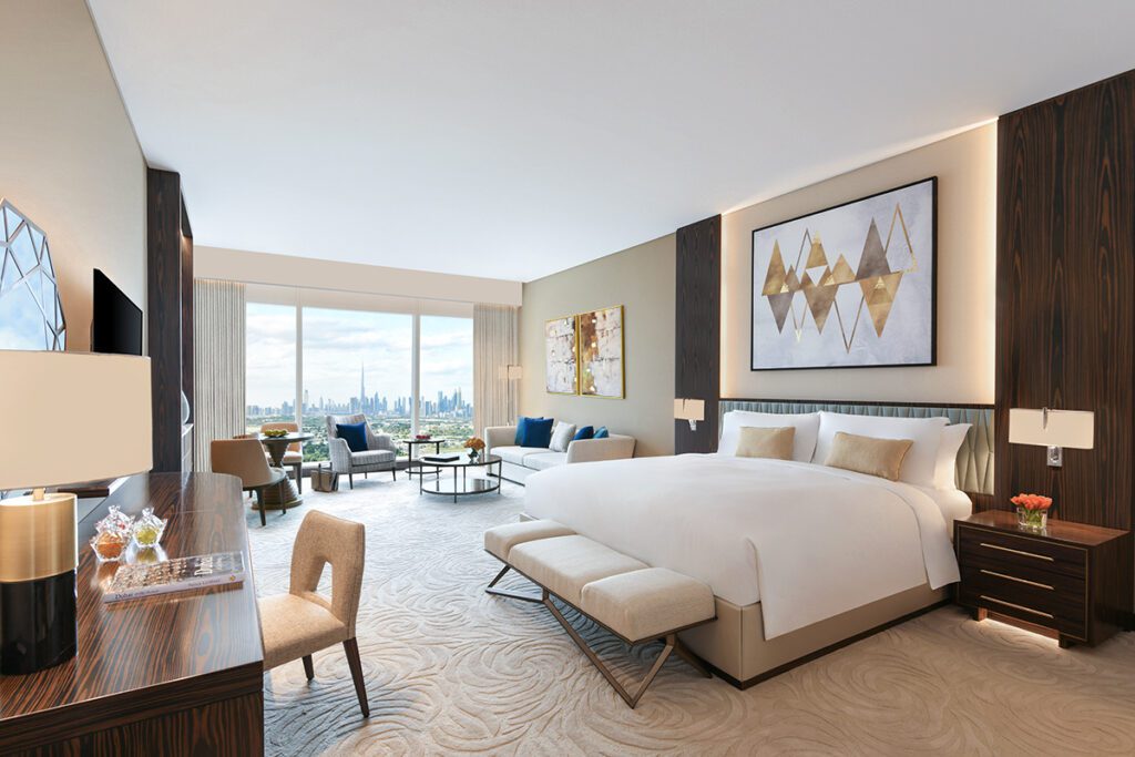 Elegant hotel room with a king-size bed, modern decor, and a stunning city skyline view.